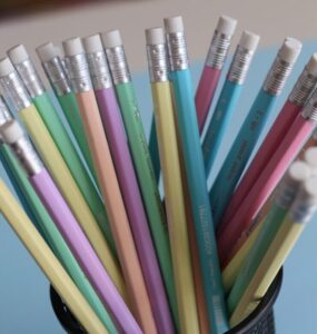 assorted-color wooden pencils on black mesh organizer